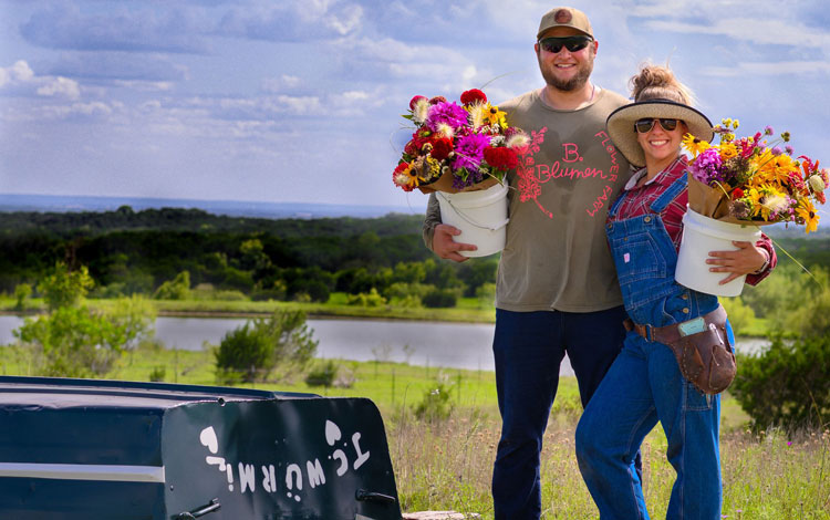 Hombre y mujer con balde de flores.